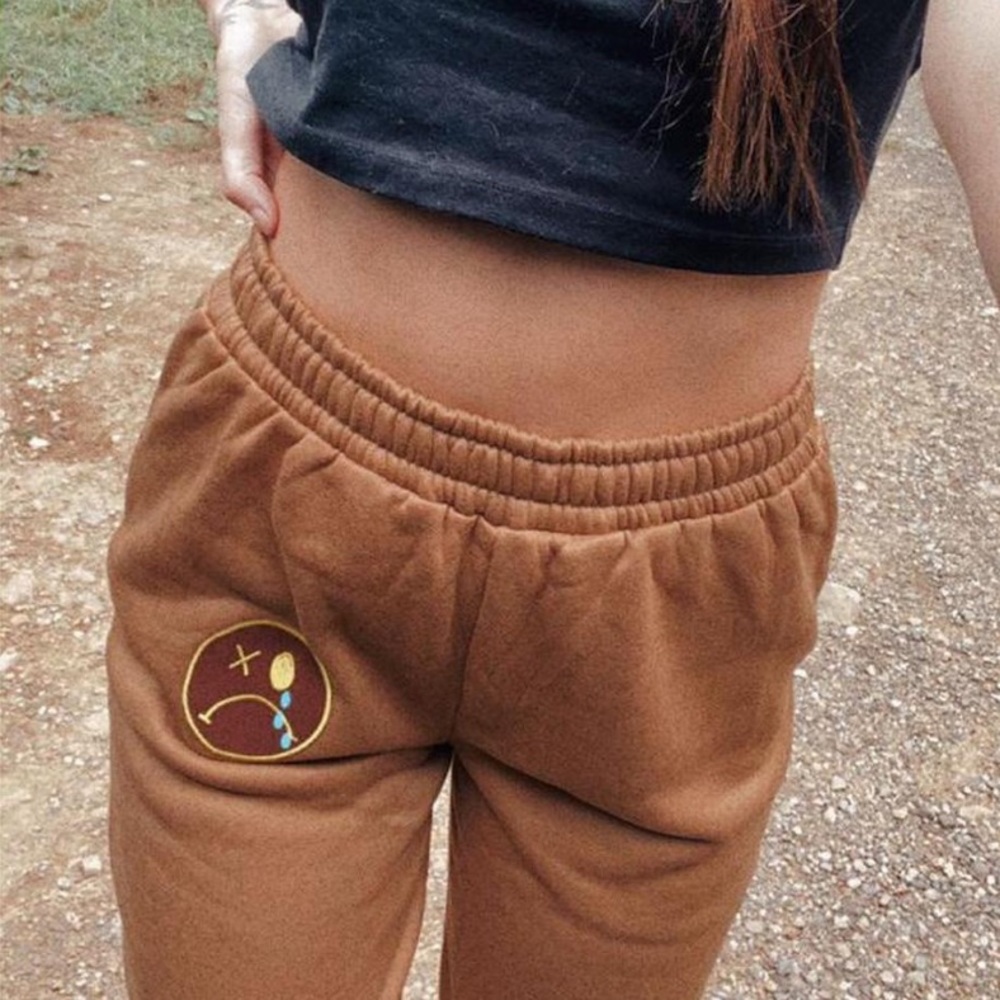 Brown sweatpants with patch emoji